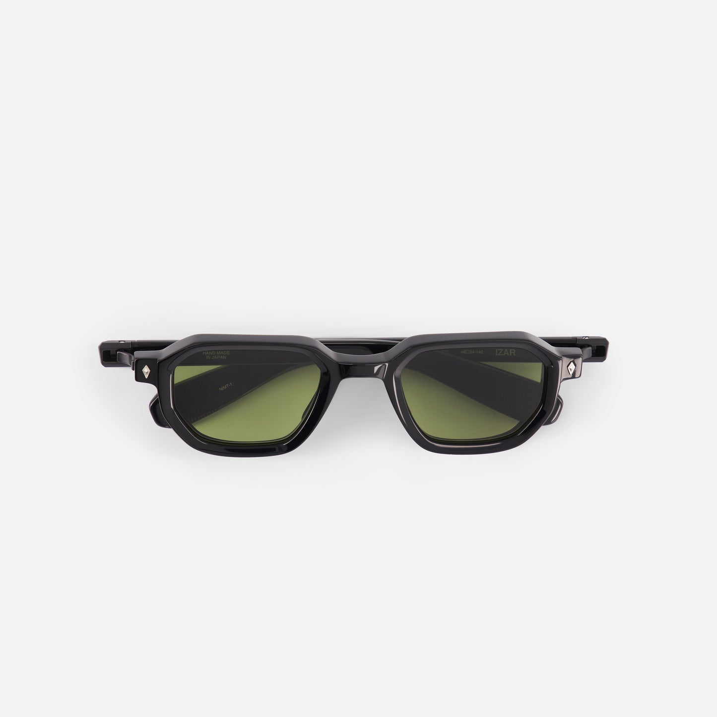 Black sunglasses with green lenses on a white background