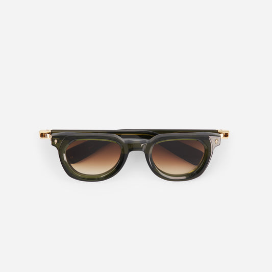 Green sunglasses with a gold frame and dark gradient brown lenses on a white background