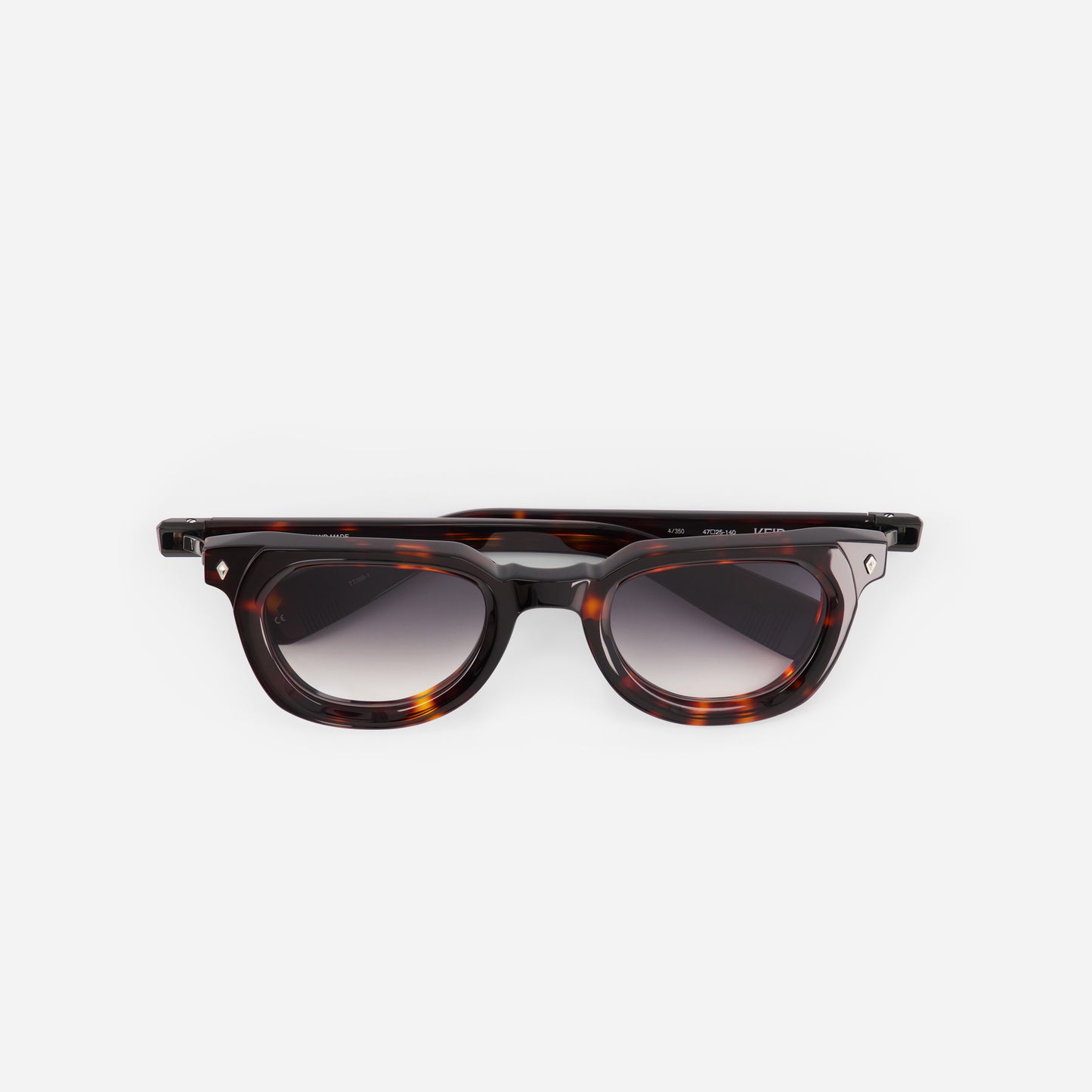 Sunglasses with tortoiseshell frame and dark grey lenses on a white background