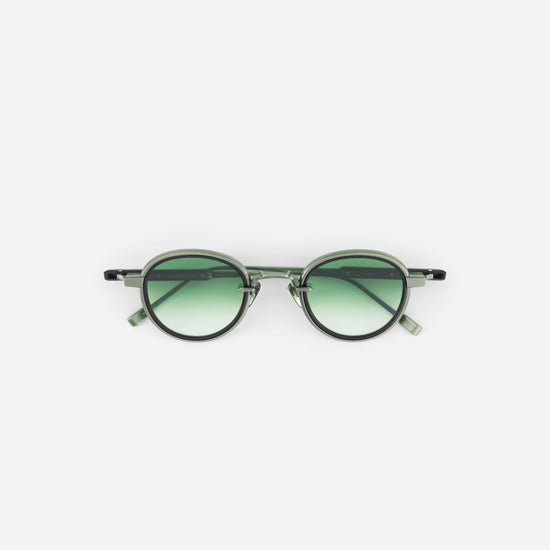 Matte green round sunglasses and green gradient lenses on a white background