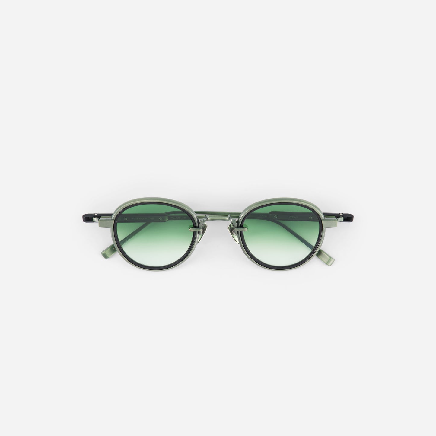 Matte green round sunglasses and green gradient lenses on a white background