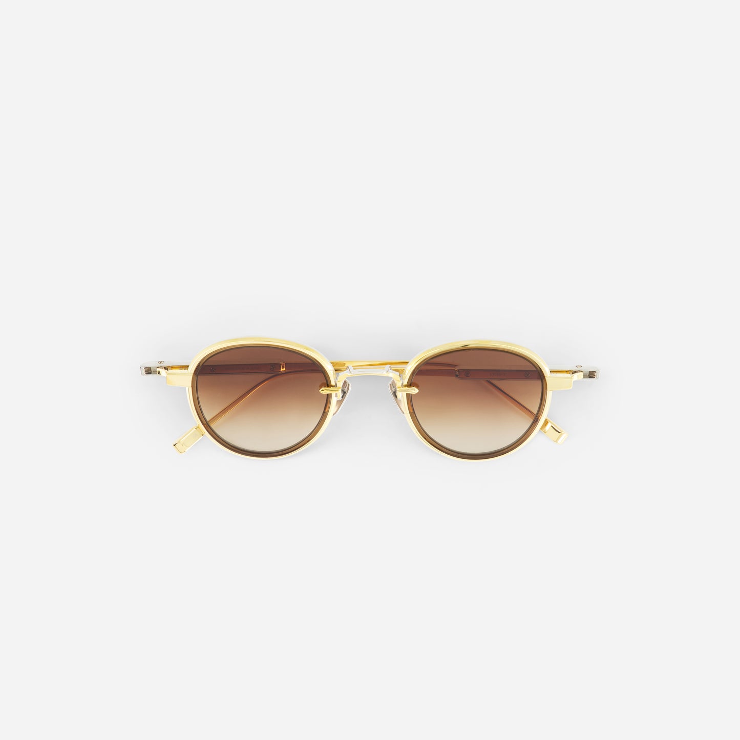 Gold-framed sunglasses with gradient brown lenses on a white background