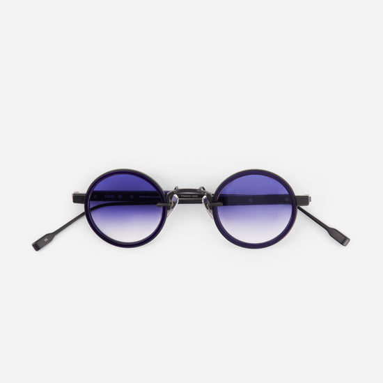 Round sunglasses with gradient purple lenses on a white background