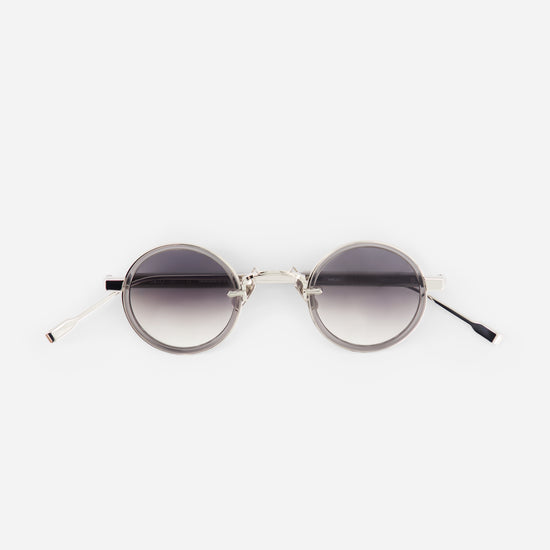 Round sunglasses with gradient lenses on a white background