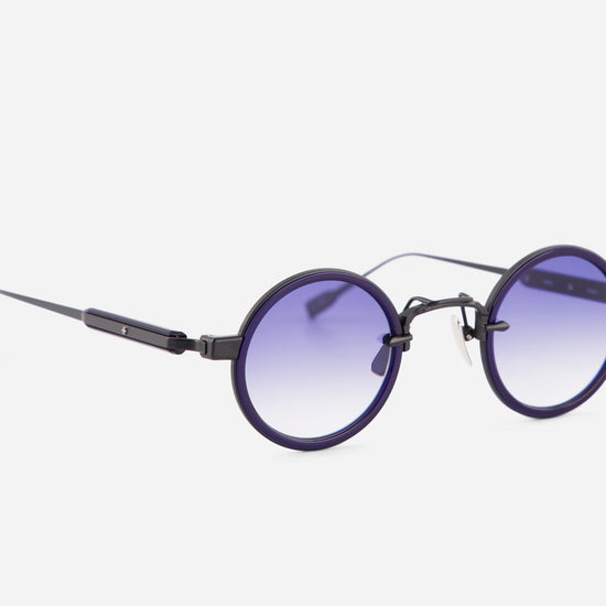Round sunglasses with purple gradient lenses on a white background