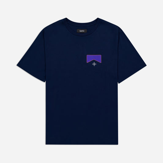 Navy blue t-shirt with a small purple logo on a light gray background