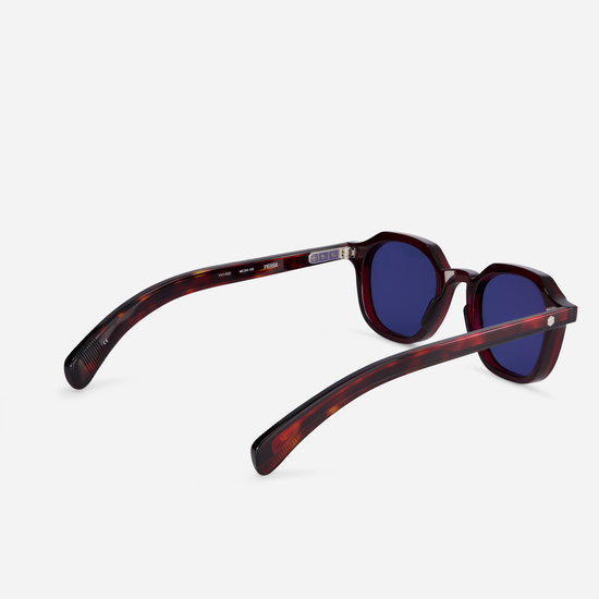 Elevate your eyewear collection with Perse PI-1, featuring a Japanese acetate frame in Poison Ivy (deep red) color and solid blue lenses.