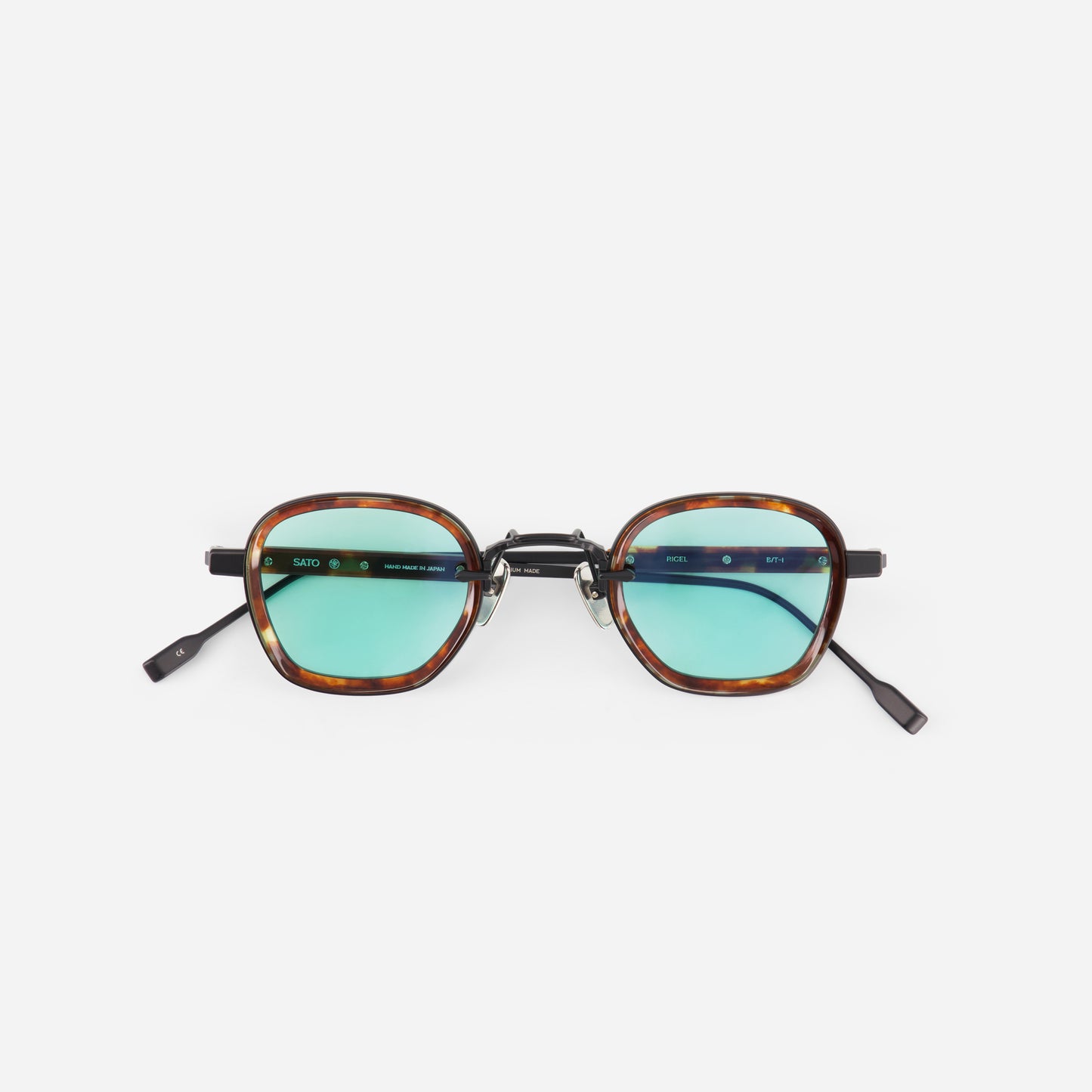 Matt black sunglasses with tortoiseshell frame and light blue lenses on a white background