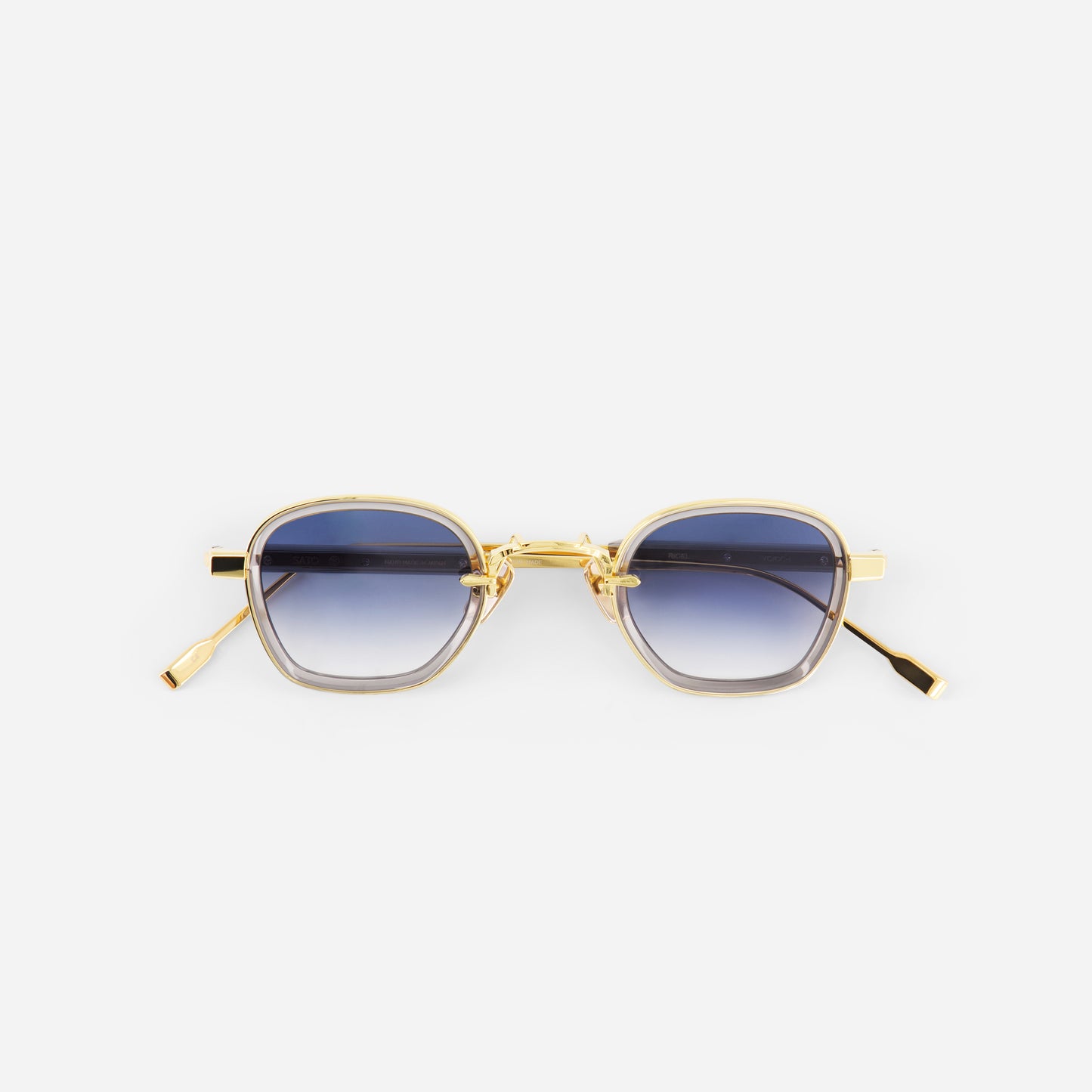 Gold-framed sunglasses with blue gradient lenses on a white background