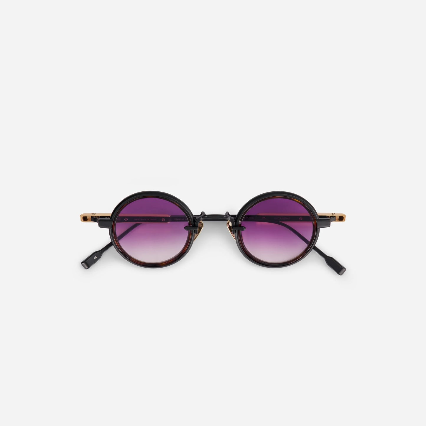 The Rotanev-T B/RG features a titanium frame with black mat and rose gold coating, tortoise takiron rim insert, and gradient purple lenses.