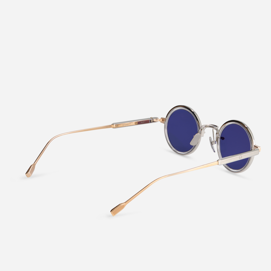 The Rotanev-T RG/P-1 eyeglasses showcase a titanium frame with rose gold and platinum coatings, a crystal takiron rim insert, and BL-16 blue lenses.
