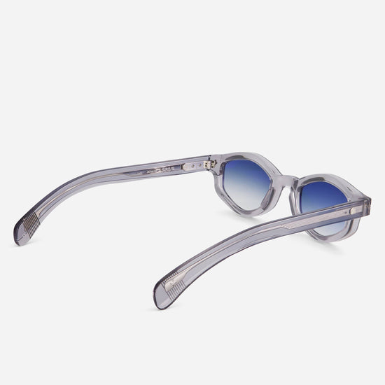 Sirius MERC-1 combines a sophisticated grey crystal frame with eye-catching blue gradient lenses, creating a chic accessory for fashion-forward individuals.