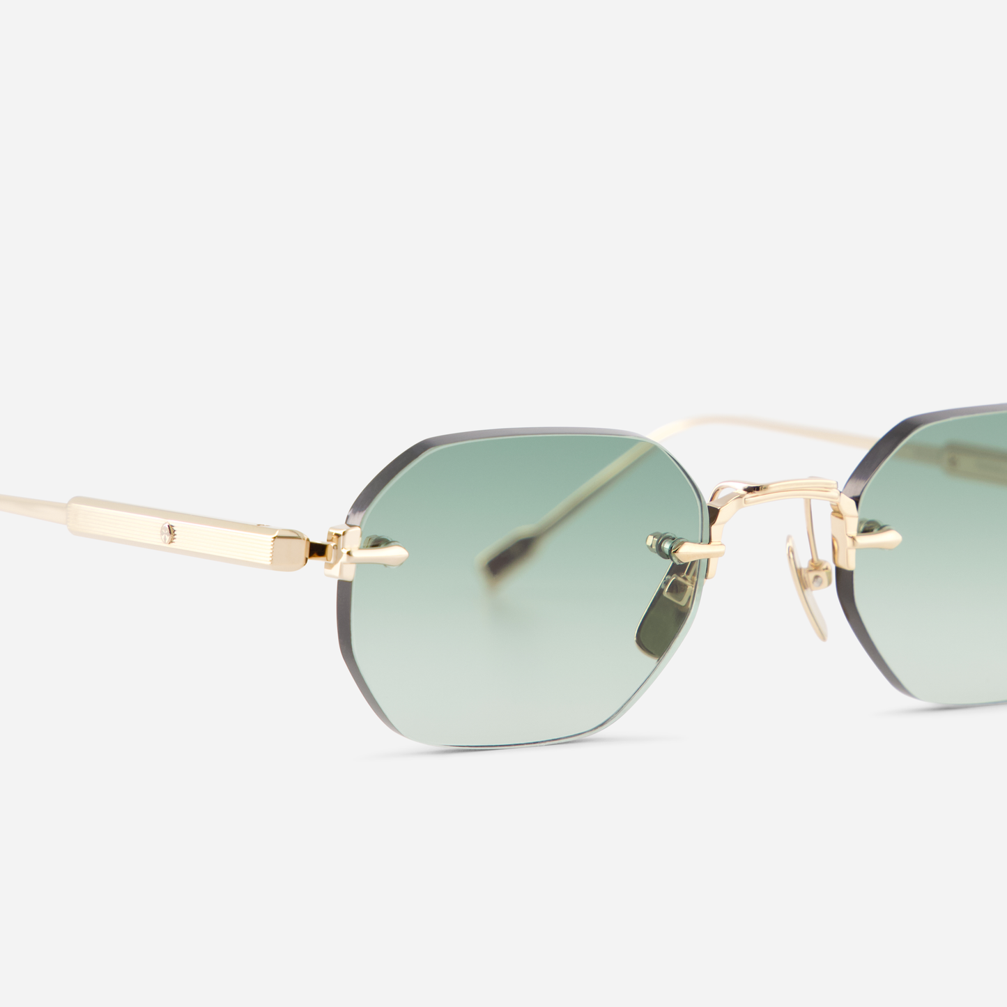 Terebellum II S702, featuring a square rimless shape, Lunar Gold embellishments, and striking gradient green lenses.