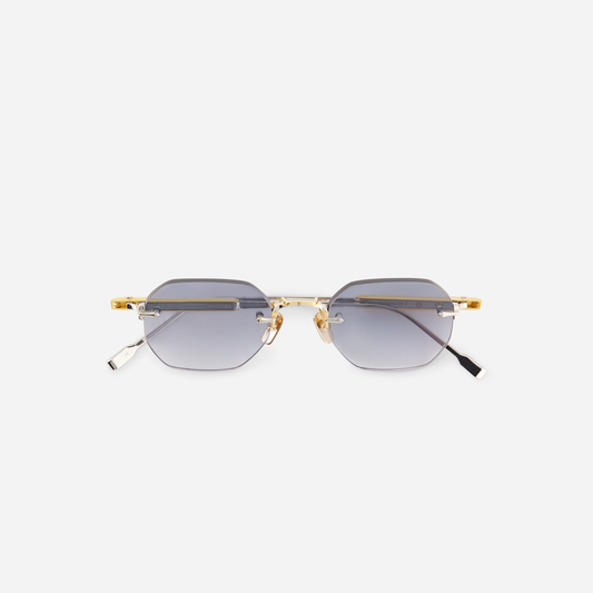Terebellum II S703, featuring yellow gold and platinum accents, a rounded hexagonal rimless design, and gradient blue lenses.