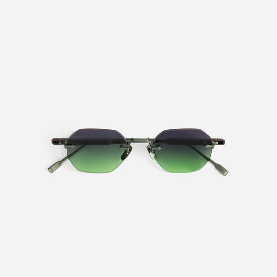 Sunglasses with green gradient lenses on a white background