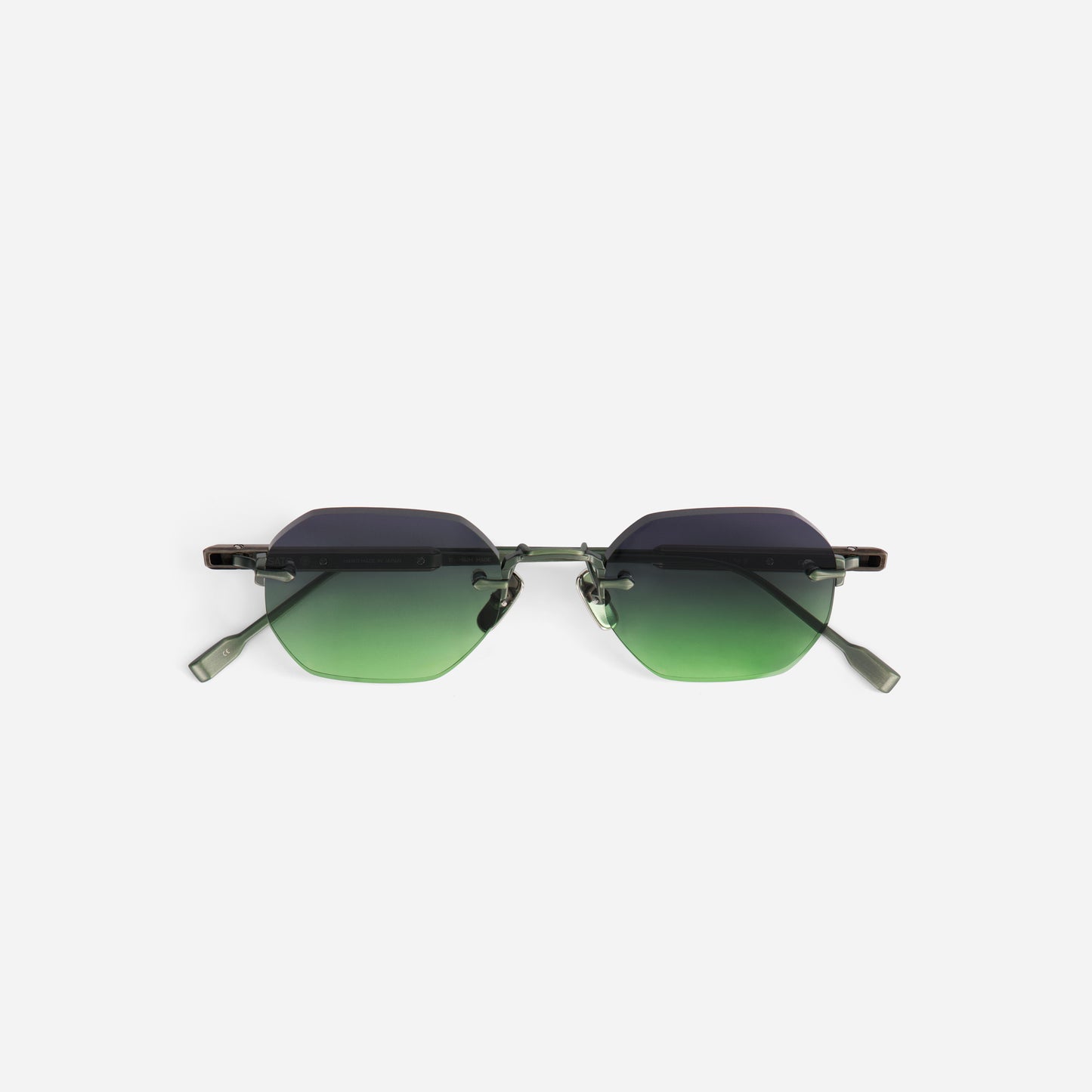 Sunglasses with green gradient lenses on a white background