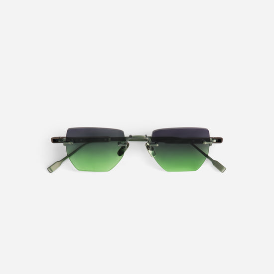 Sunglasses with grey/green gradient lenses on a white background