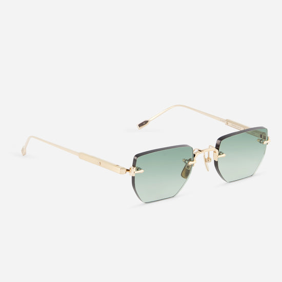 Sunglasses with gold frame and light grey lenses on a white background