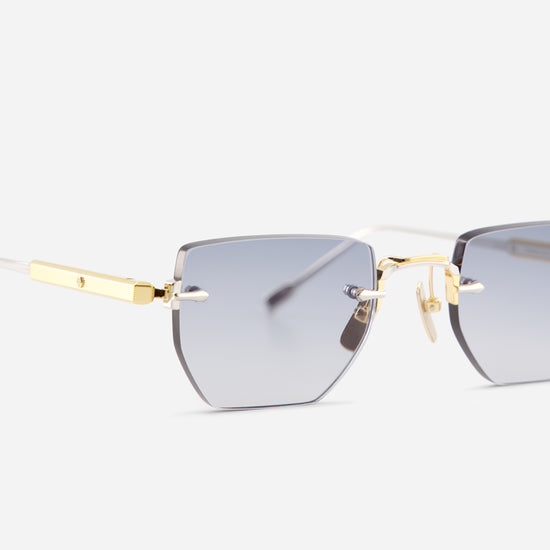 Rimless square sunglasses with gradient gray lenses and gold metal hardware, shown on a light gray background.