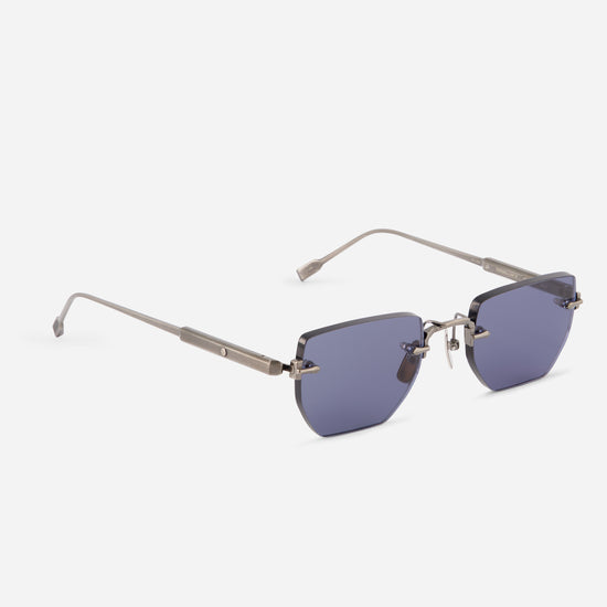 Rimless sunglasses with geometric blue-purple lenses and a silver metal frame, shown on a light gray background.