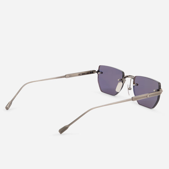 Rimless square sunglasses with a matte silver titanium frame and dark blue lenses, shown from a side angle on a light gray background.