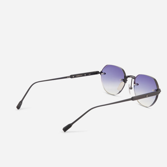 Oversized square sunglasses with a dark gunmetal frame and gradient purple-to-clear lenses, shown from a three-quarters angle on a light gray background.