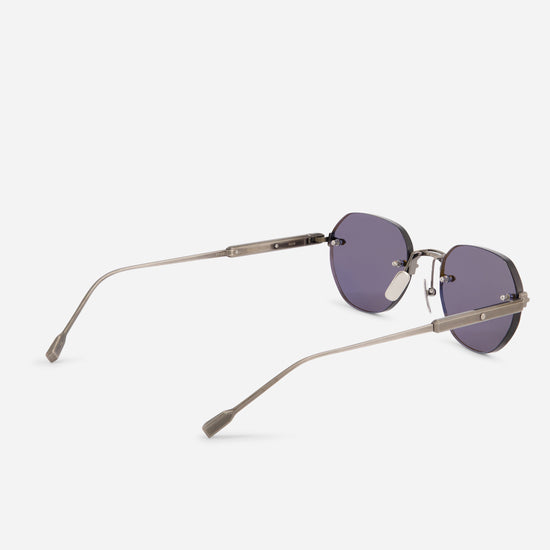 Oversized square sunglasses with dark purple lenses and slim metallic temples, shown from a side angle on a light gray background.