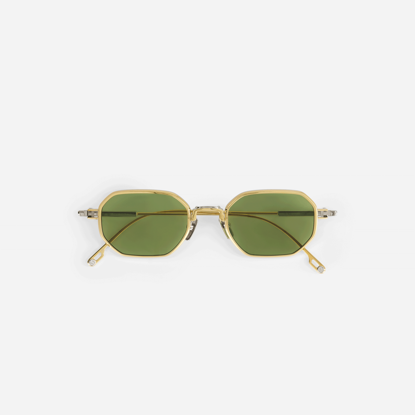 Timir S502 hexagonal glasses, meticulously crafted from pure Japanese titanium in the elegant Yellow Gold and Platinum colors, featuring captivating green lenses.