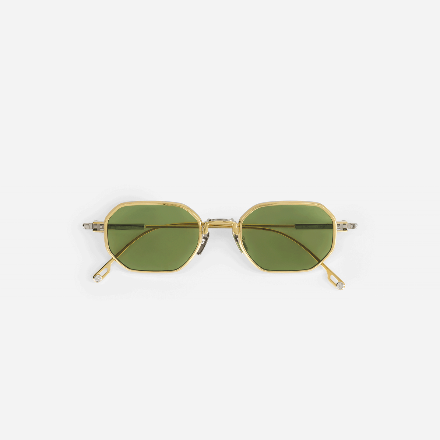 Timir S503 hexagonal glasses, meticulously crafted from pure Japanese titanium in the elegant Yellow Gold and Platinum colors, featuring captivating green lenses.