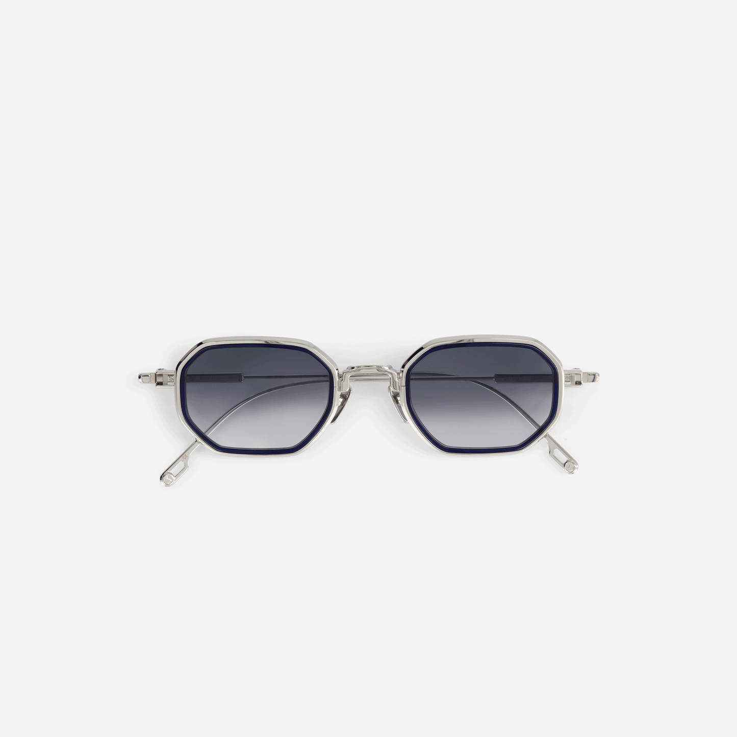 Timir-T S5501 hexagonal glasses. These limited edition frames are meticulously crafted from pure palladium titanium, featuring stylish grey gradient tinted lenses and a captivating midnight blue Takiron insert for a truly unique and exclusive eyewear experience.