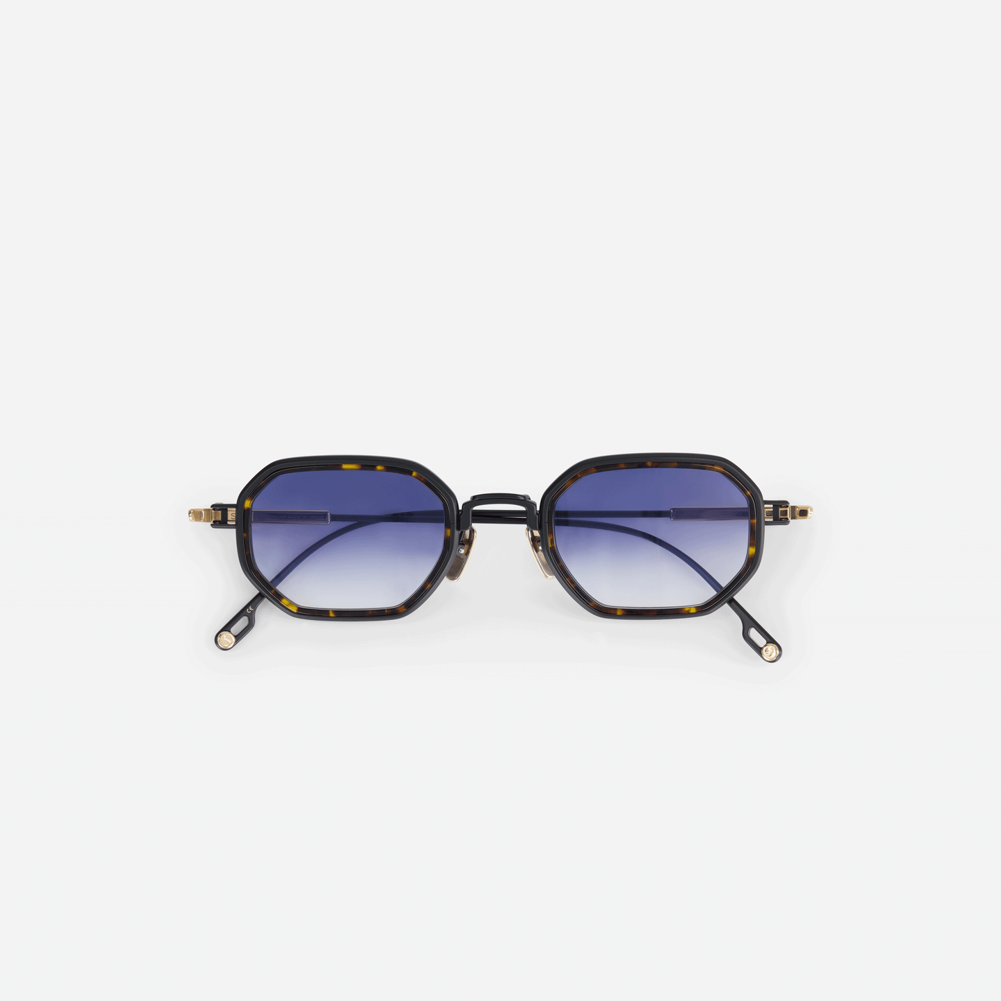 Timir-T S5506 glasses, meticulously crafted from pure black gold and lunar gold titanium frames, featuring a tortoise Takiron insert and dark blue gradient lenses.