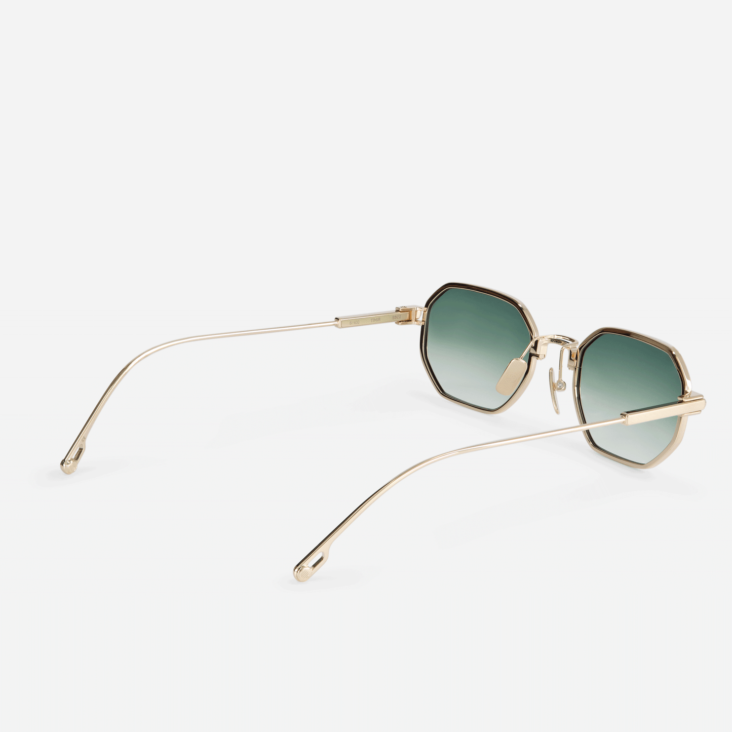  Timir S502 hexagonal glasses, expertly fashioned from luxurious Japanese titanium in the captivating Lunar Gold finish, accompanied by captivating olive gradient lenses.