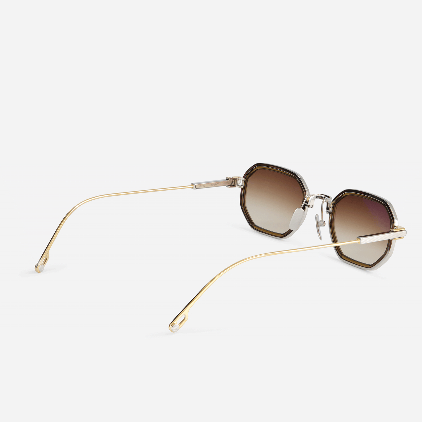 Timir-T S5503 glasses, meticulously constructed from pure titanium in yellow gold and platinum, with a luxurious chocolate brown Takiron insert and alluring gradient brown lenses, adding a touch of warmth to your style.