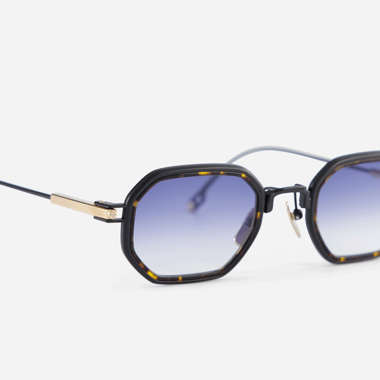 Timir-T S5506 glasses, meticulously constructed from pure black coated and lunar gold titanium frames, highlighted by a chic tortoise Takiron insert and dark blue gradient lenses.