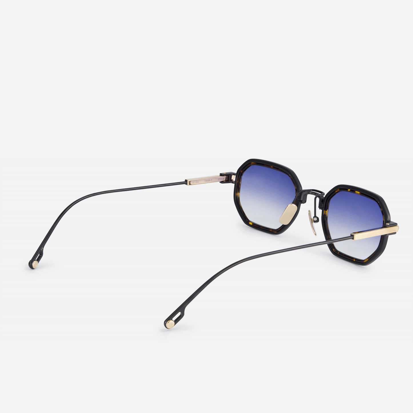 Timir-T S5506 glasses, featuring sleek pure black coated and lunar gold titanium frames, a sophisticated tortoise Takiron insert, and captivating dark blue gradient lenses.