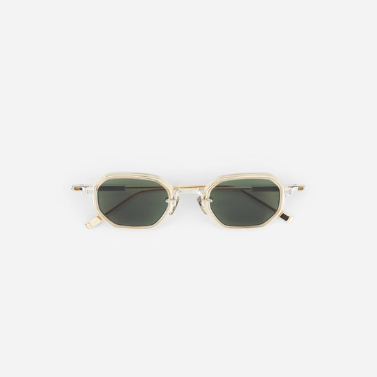 Sunglasses with gold frame and dark lenses on a white background