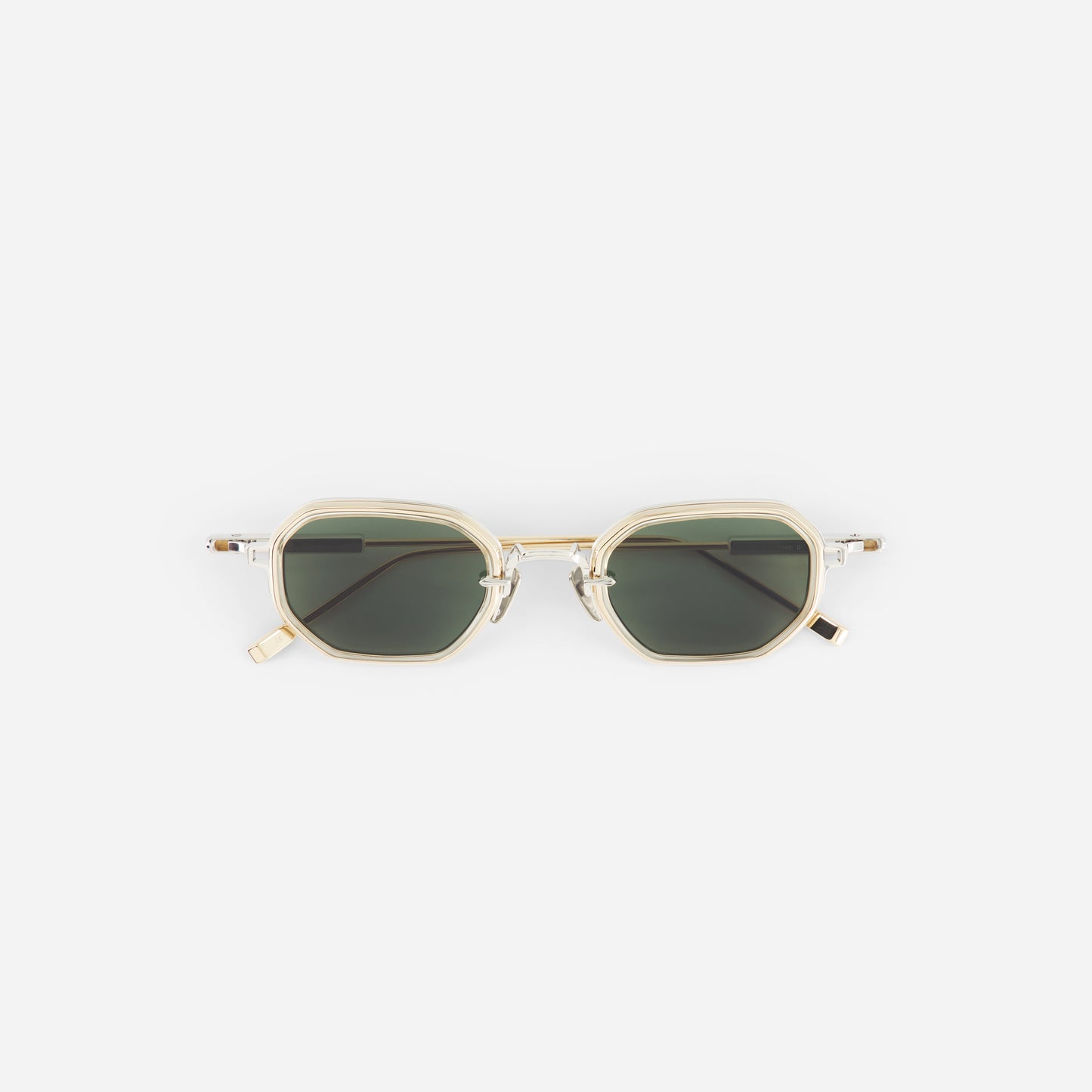 Sunglasses with gold frame and dark lenses on a white background
