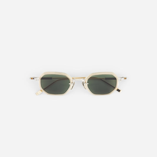 Sunglasses with gold frame and dark lenses on a white background