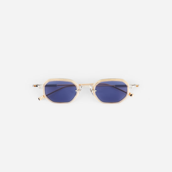 Gold-framed sunglasses with blue lenses on a white background