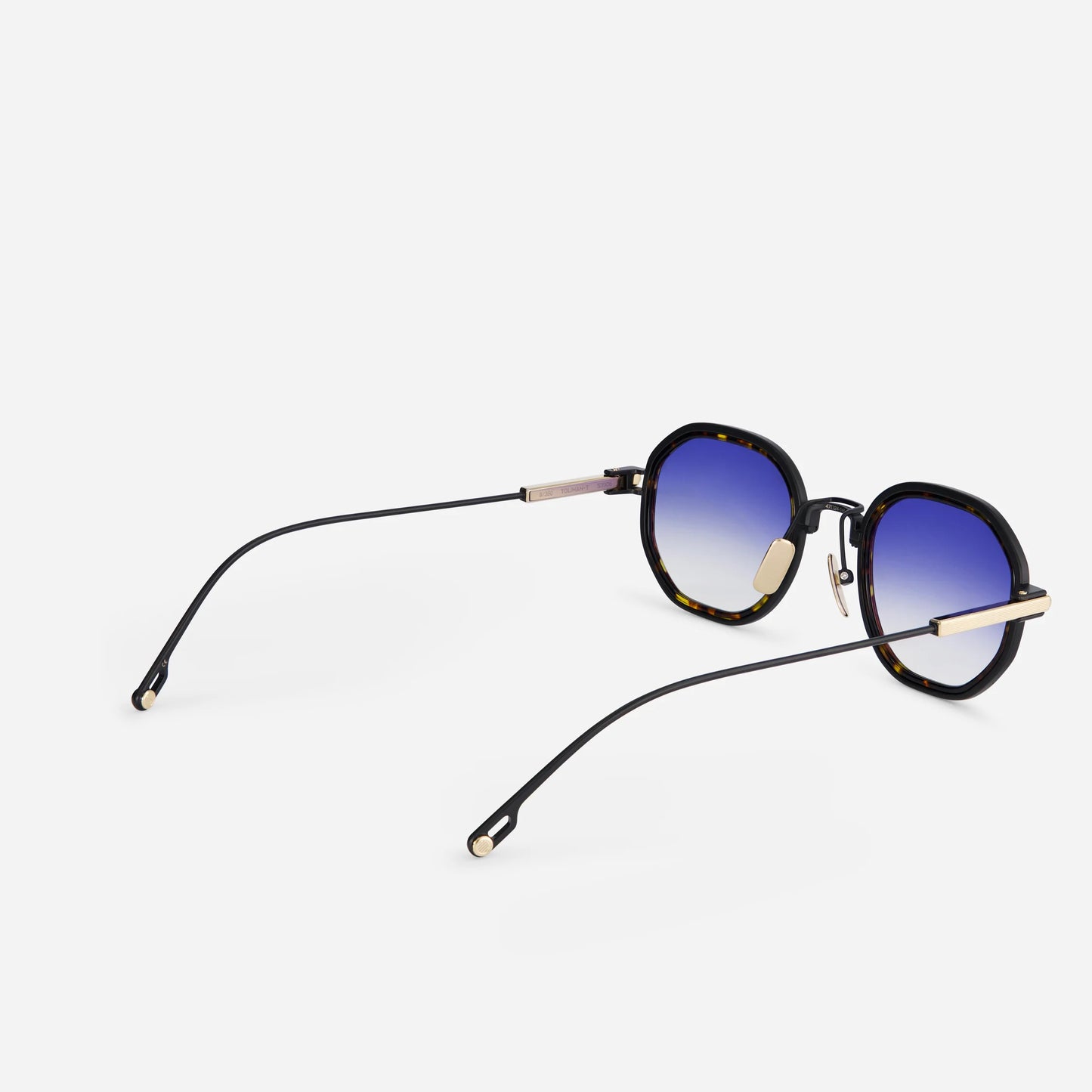 Toliman-T S3306 hexagonal sunglasses. Made from pure black titanium, these exquisite eyewear pieces feature dark blue gradient lenses and a stylish tortoise takiron rim insert.