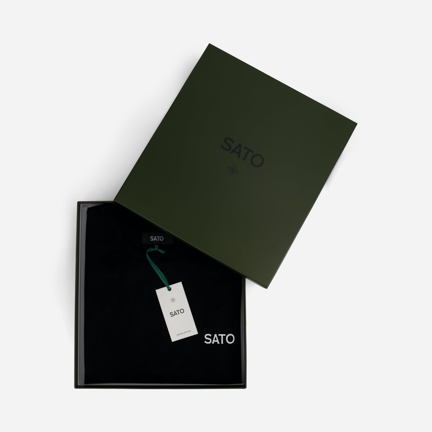 Black and green Sato branded box with a tag on a white background
