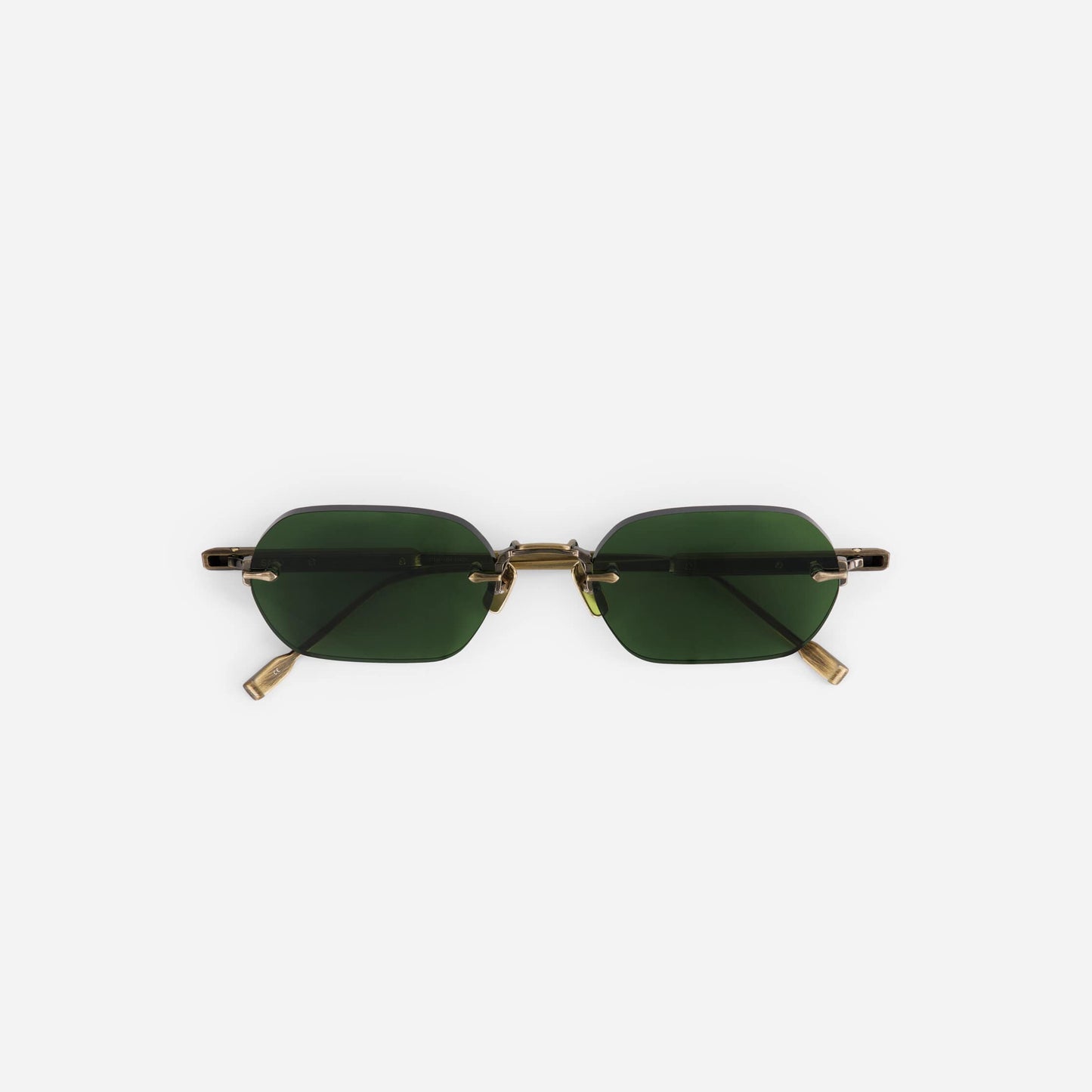 Terebellum IV S1009 sunglasses in antique gold feature a rimless design with dark green lenses.