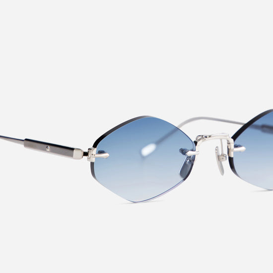 The Terebellum V S1201 combines a platinum frame with a rimless silhouette, complemented by elegant blue gradient lenses.