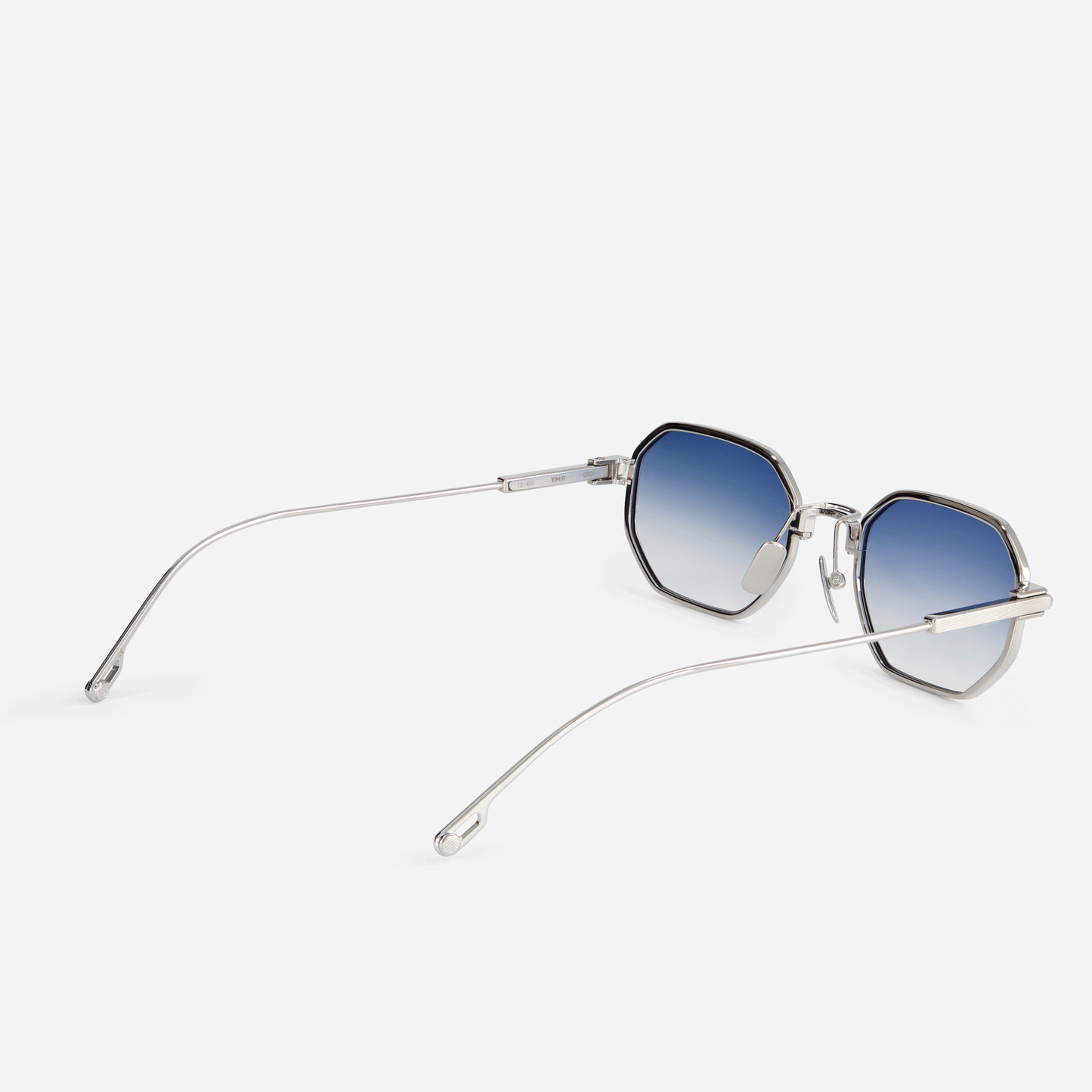 Timir S501 hexagonal glasses, meticulously constructed from high-grade Japanese titanium and featuring sleek blue gradient lenses for a captivating look- side view. Sato eyewear.