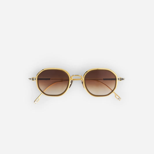 Toliman-T S3303 I hexagonal sunglasses. Crafted from pure yellow gold and silver titanium, these eyewear pieces feature brown gradient lenses and a captivating chocolate brown insert.