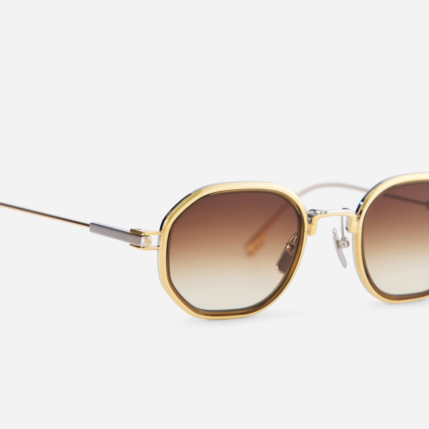 Toliman-T S3303 I hexagonal sunglasses, meticulously crafted in pure yellow gold and silver titanium. These eyewear pieces showcase brown gradient lenses and a decadent chocolate brown insert.