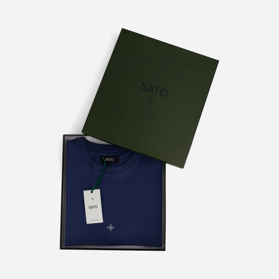 Navy blue sweater with 'SATO' branding in an open green box on a white background
