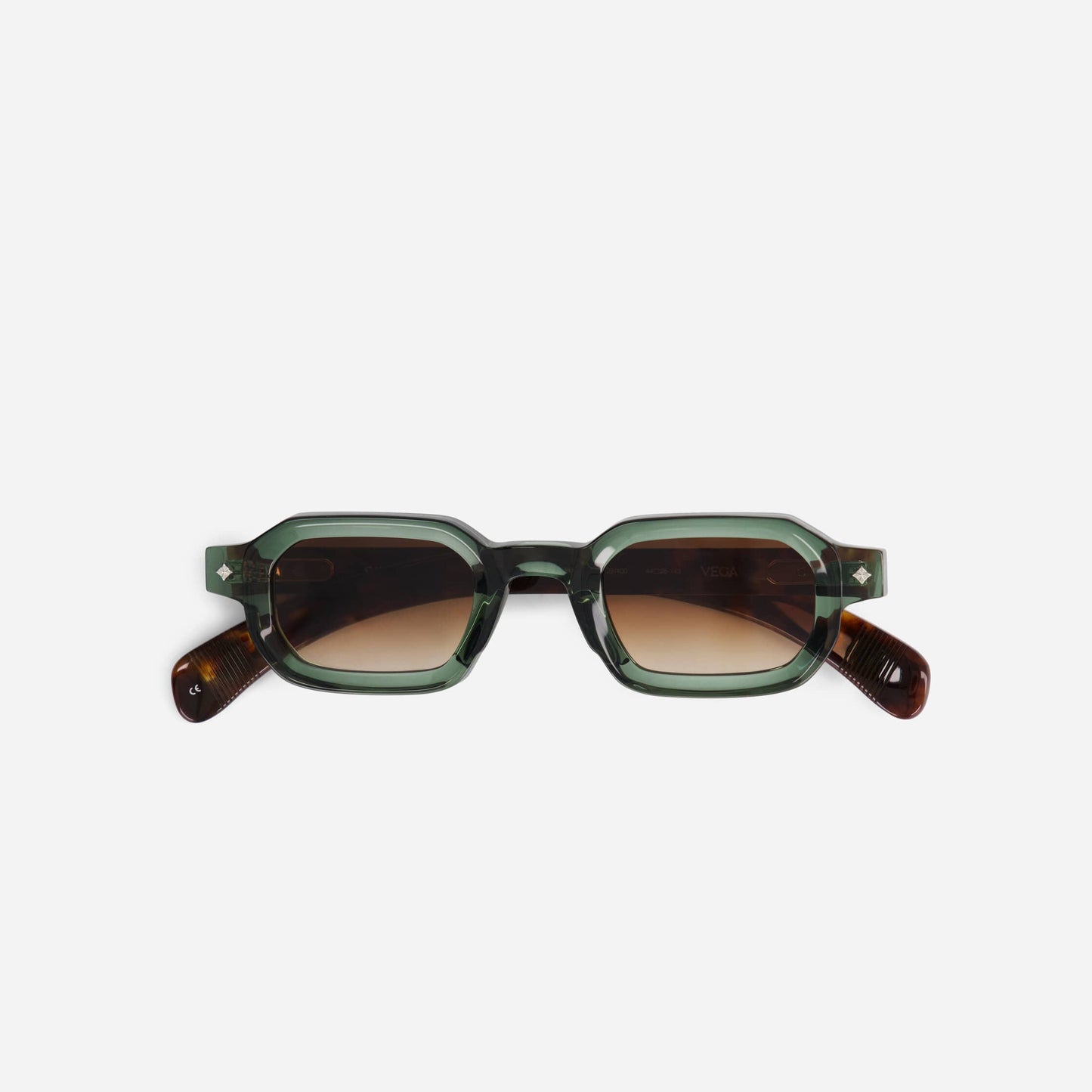 Vega VI-1 spectacles feature a bold green and tortoise frame with brown gradient lenses, enhanced by sleek silver details.