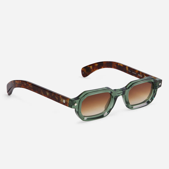 The Vega VI-1 sunglasses showcase a unique combination of green and tortoise, complemented by silver accents and warm brown gradient lenses.