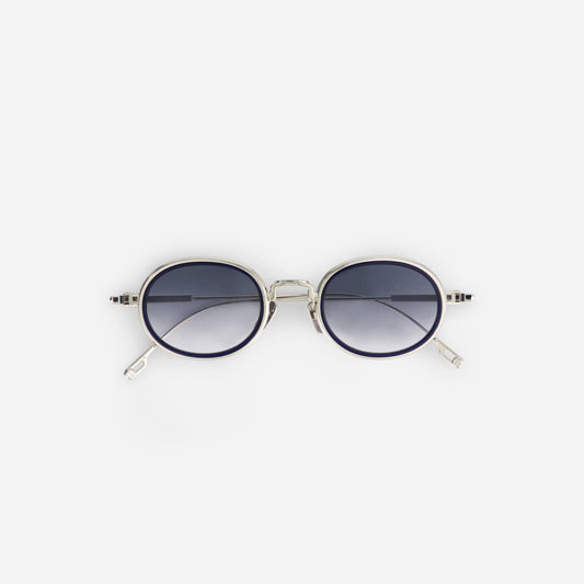 Sato unisex sunglasses with a silver titanium frame and gradient silver grey lenses